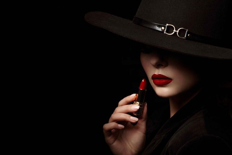 Woman using lipstick and wearing head